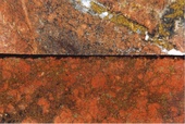 Vesicular magnetite altered porphyry with haematite albite overprint